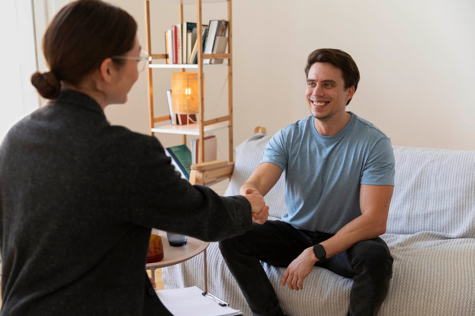 A small, quiet support group sitting in a circle in a warm room